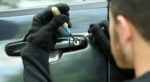 Thief Breaking the lock on a Used Car