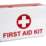 White and red box with a plus symbol and the words "First Aid Kit" printed on it against a white background