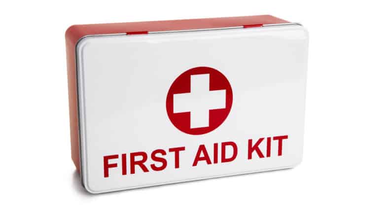 White and red box with a plus symbol and the words "First Aid Kit" printed on it against a white background