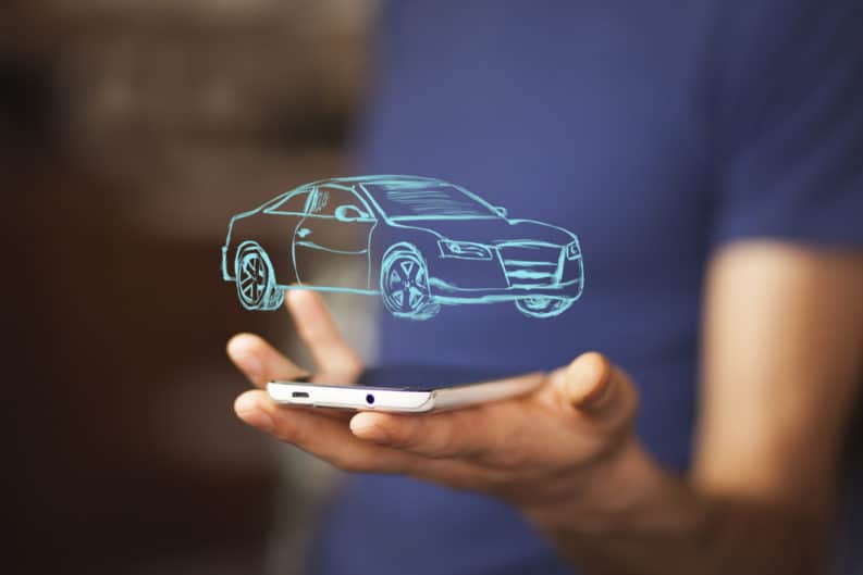 Man holding an iPhone with a hologram of a special car offer.