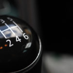 Black and silver stick shift with white letters and numbers