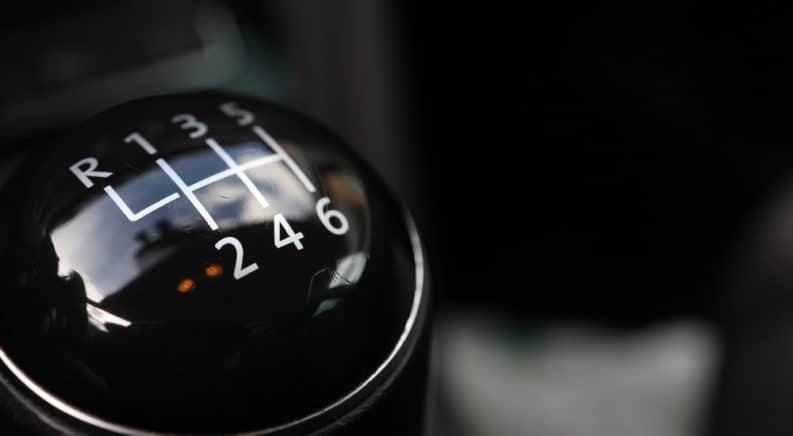 Black and silver stick shift with white letters and numbers