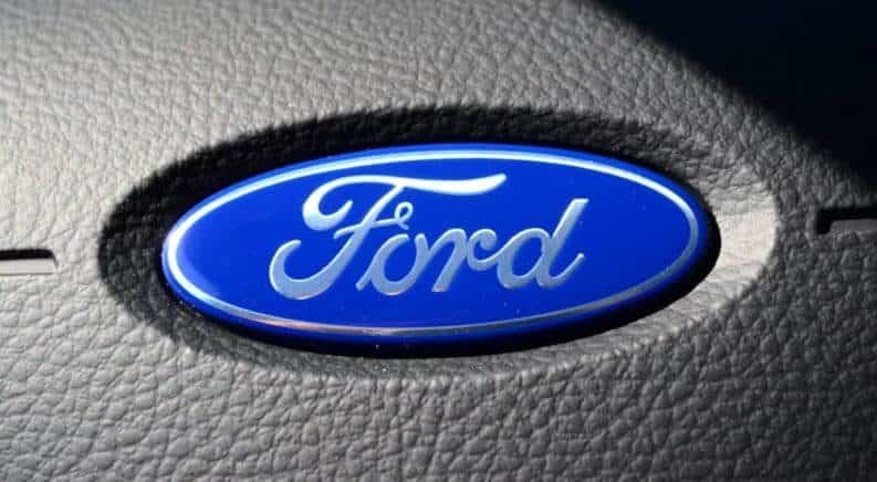 Blue Ford logo on leather steering wheel