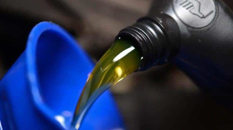 Oil being poured into a funnel