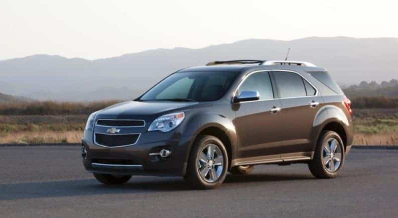 Brown 2013 Chevy Equinox with mountains in back
