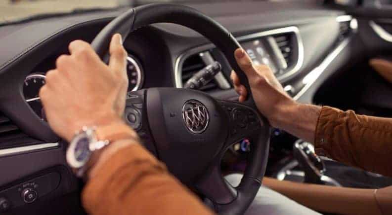 Closeup of hands on 2019 Buick Enclave steering wheel