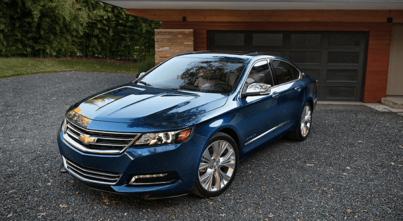 Blue 2019 Chevy Impala in front of garage