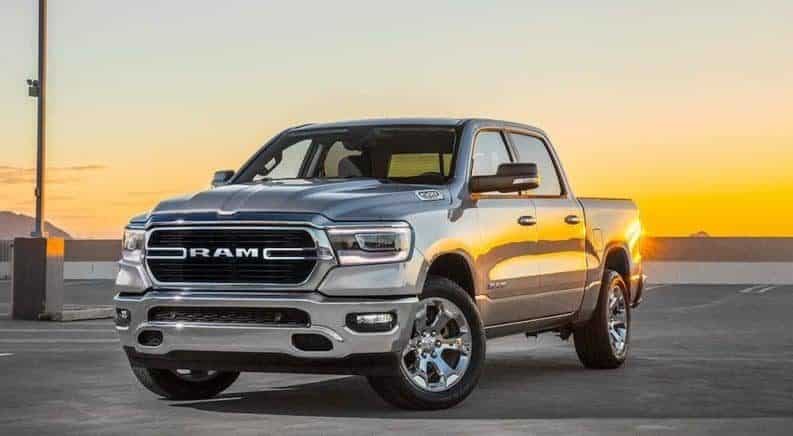 Silver 2019 Ram 1500 in parking lot at sunset