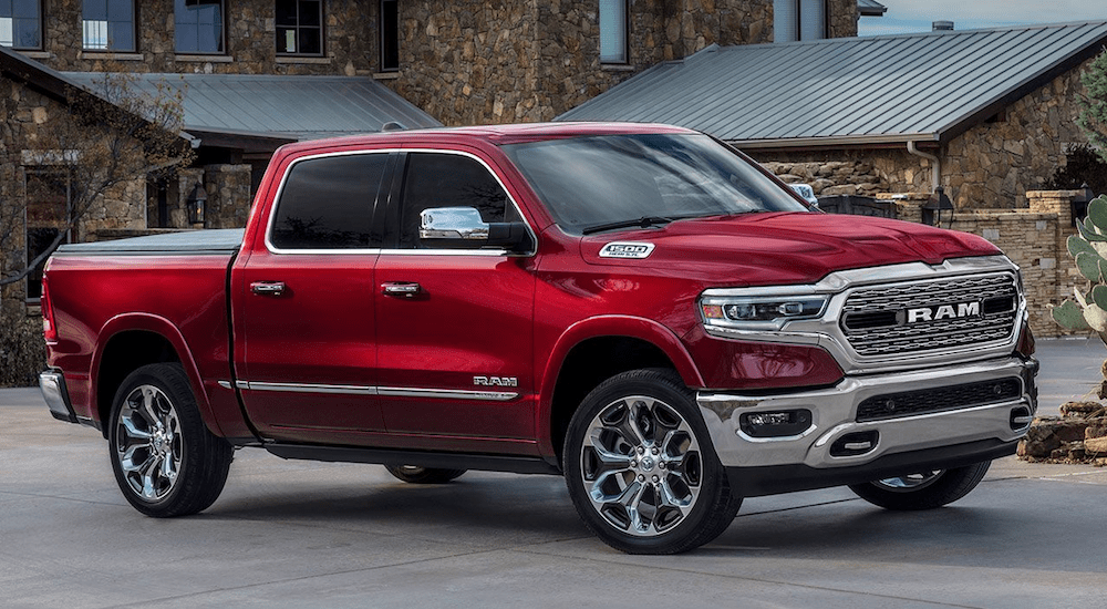 Red 2019 Ram 1500 in front of stone mansion