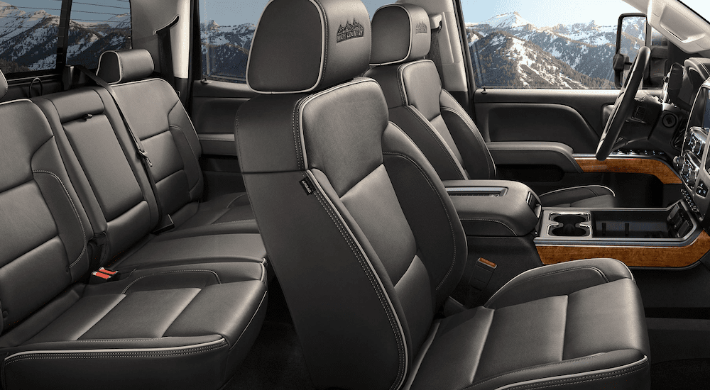 Black leather interior of 2019 Chevy Silverado HD with High Country embroidered into headrest