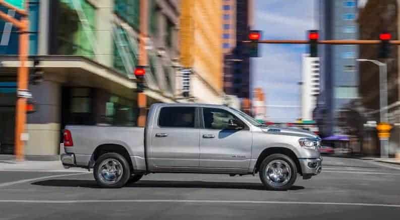Silver 2019 Ram 1500 driving in city