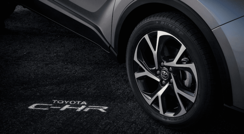 Closeup of gray 2019 Toyota C-HR wheel with logo lighting on ground