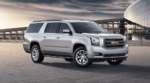Silver 2019 GMC Yukon XL in front of glass builing
