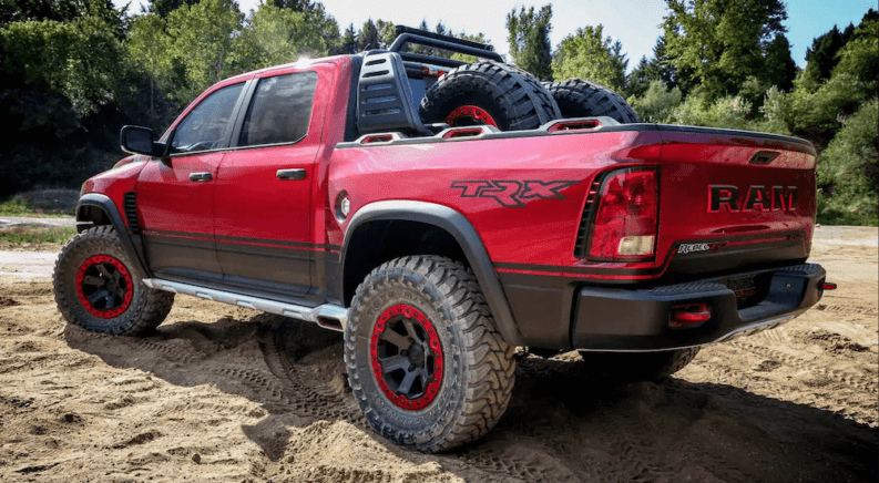 Red Ram Rebel TRX from driver-side rear while off road