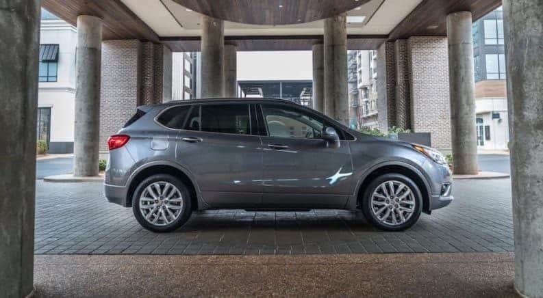 A gray 2019 Buick Envision under a fancy entry way
