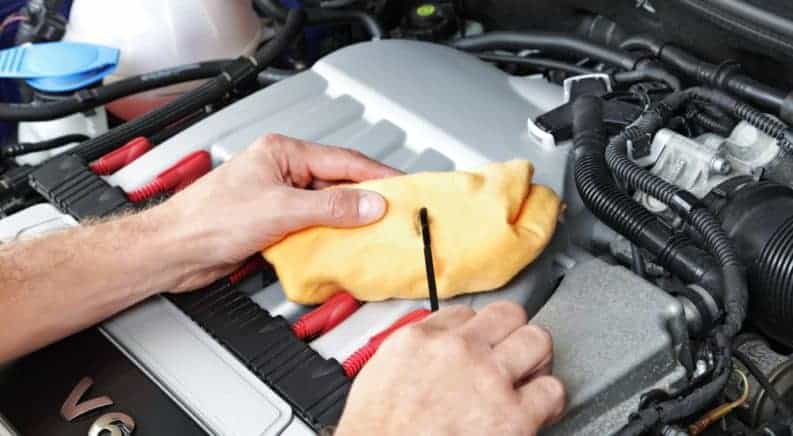 A tech performing an oil change on a car