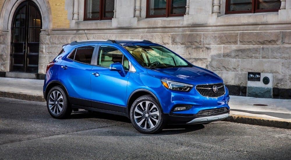 A blue 2019 Buick Encore in front of a brick building