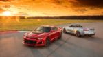 Red and silver 2019 Chevy Camaros on a track at sunset
