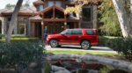 A red 2019 Chevy Tahoe rests easy in front of a mansion when it comes to 2019 Chevy Tahoe vs 2019 Ford Expedition