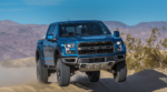 A blue Ford jumps over dunes and the competition in 2019 Ford F-150 vs 2019 Nissan Titan