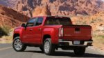 A red 2019 GMC Canyon in a desert canyon