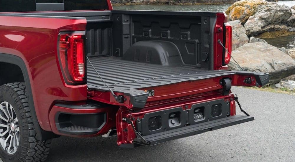 A red 2019 GMC Sierra AT4 with an open multipro tailgate
