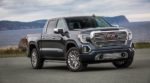 Standing victorious from a 2019 GMC Sierra 1500 vs 2019 Chevy Silverado, a black Sierra sits in front of a body of water