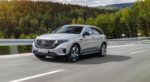 A silver 2020 Mercedes EQC EV travels a mountain road