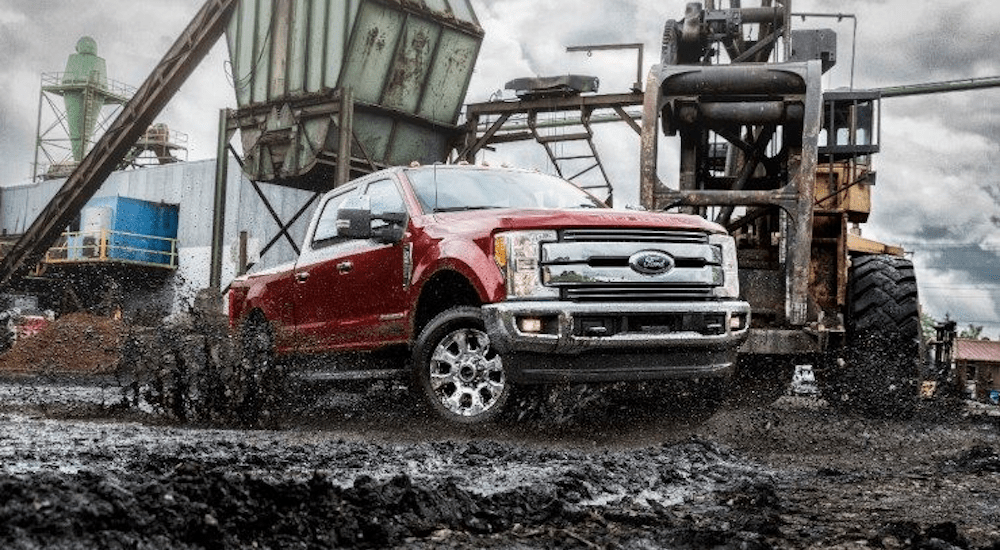 Burgundy 2018 Ford F 250 on muddy construction site
