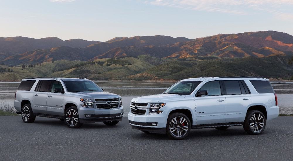 Silver 2019 Chevy Suburban and White Tahoe