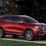 A red 2019 Terrain Denali in front of a nice home after comparing 2019 GMC Terrain vs 2019 Nissan Rogue