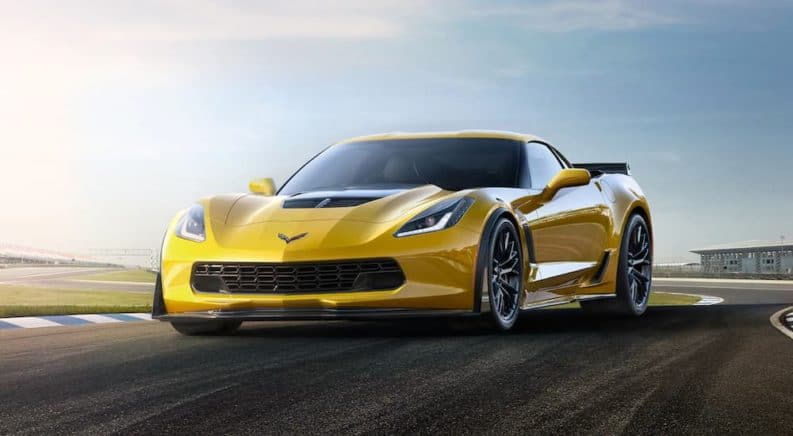 A yellow 2019 Chevy Corvette z06 is parked on a track. It is one of the Chevy cars in the performance class.