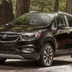 A black 2019 Buick Encore is on a tree lined trail.