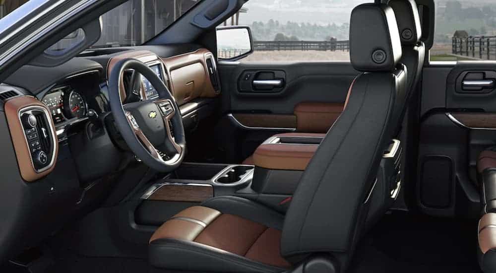 The brown and black interior of a 2019 Chevy Silverado 1500 is show. Check out technology when comparing the 2019 Chevy Silverado vs 2019 Ford F-150.
