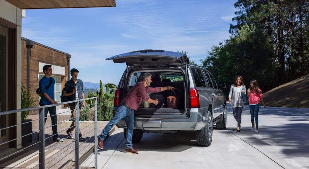 A family is loading up their 2019 grey Chevy Suburban.