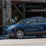 Two women are walking to their blue 2019 Chevy Trax outside a cafe.
