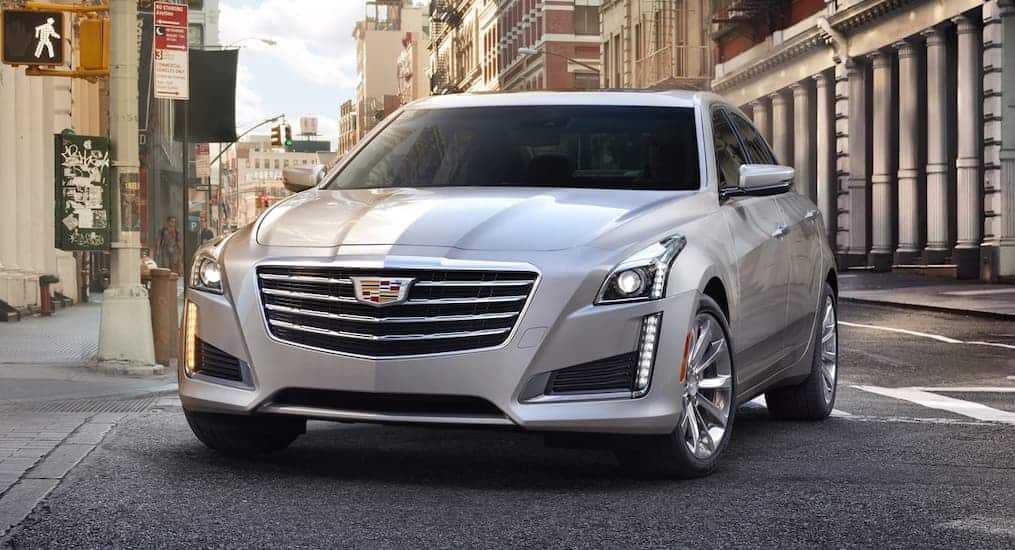 A silver 2019 Cadillac CTS is shown from the front at an angle parked on a city street.