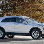 A silver 2019 Cadillac XT4 is parked in a snowy area and is a popular Cadillac for sale.
