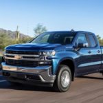 A blue 2019 Chevy Silverado 1500, one of the popular trucks for sale, is driving through the desert.