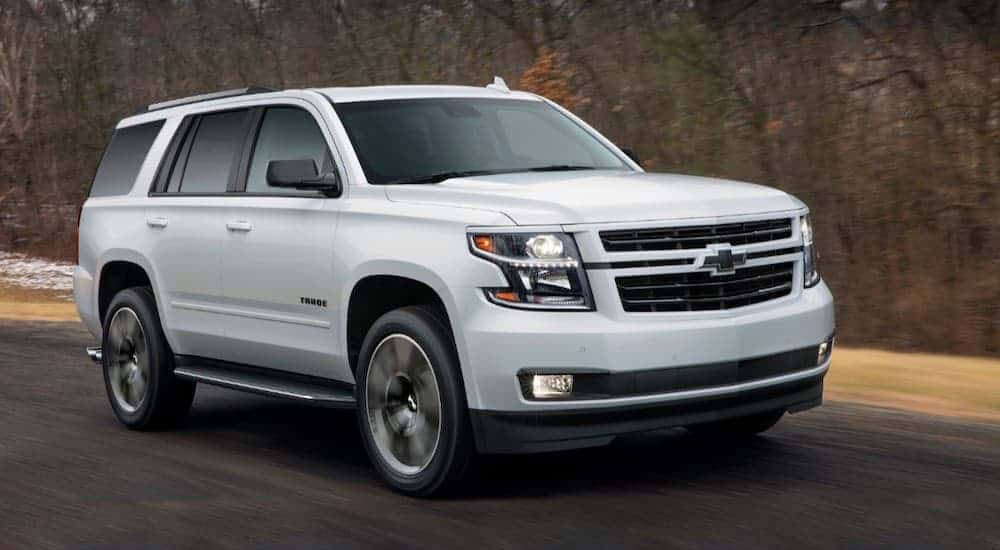 A white 2018 Chevy Tahoe is shown driving in fall.