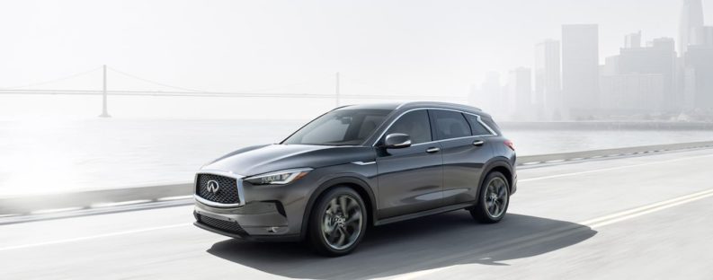 A 2019 grey Infiniti QX50 is shown driving on a highway.