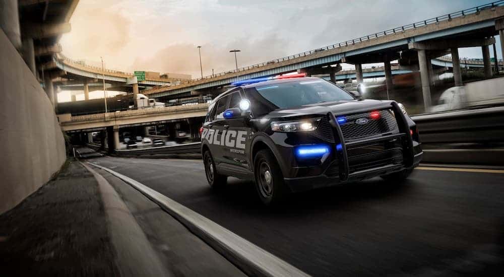 A 2020 Ford Explorer Interceptor is driving on a highway.
