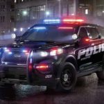 A 2020 Ford Explorer Interceptor is parked with lights on at night.
