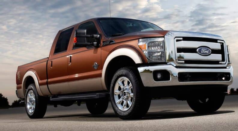 A brown 2009 Ford F-250 is shown from a low angle with sky above.