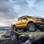 A gold 2019 Ford Ranger is shown on a rocky area from a low angle.