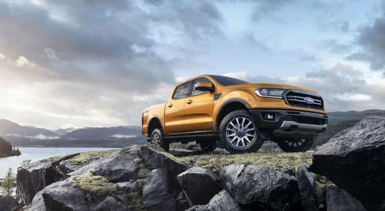 A gold 2019 Ford Ranger is shown on a rocky area from a low angle.