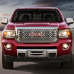 A red 2019 GMC Canyon Denali is shown in an open area.