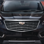 A black 2019 Cadillac XT5 is on a cobble road.