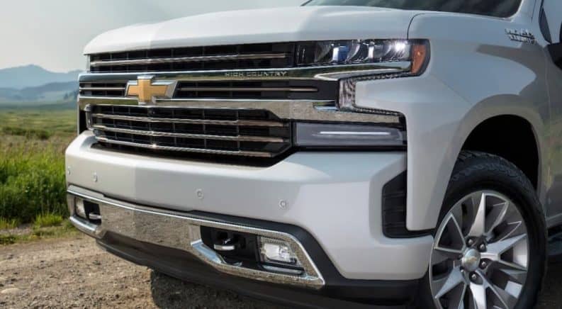 The front end of a white 2019 Chevrolet Silverado HighCountry is shown.