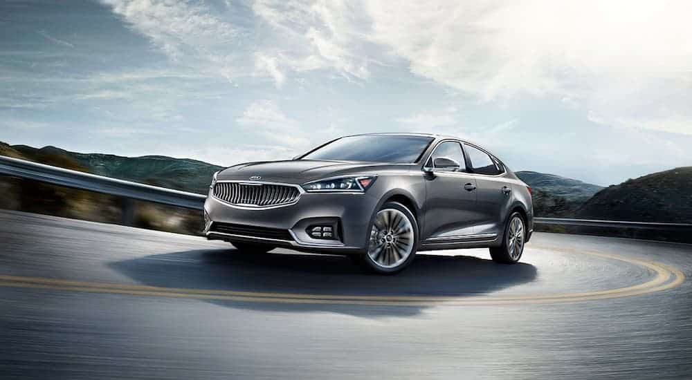 A grey 2019 Kia Cadenza is driving on the highway.